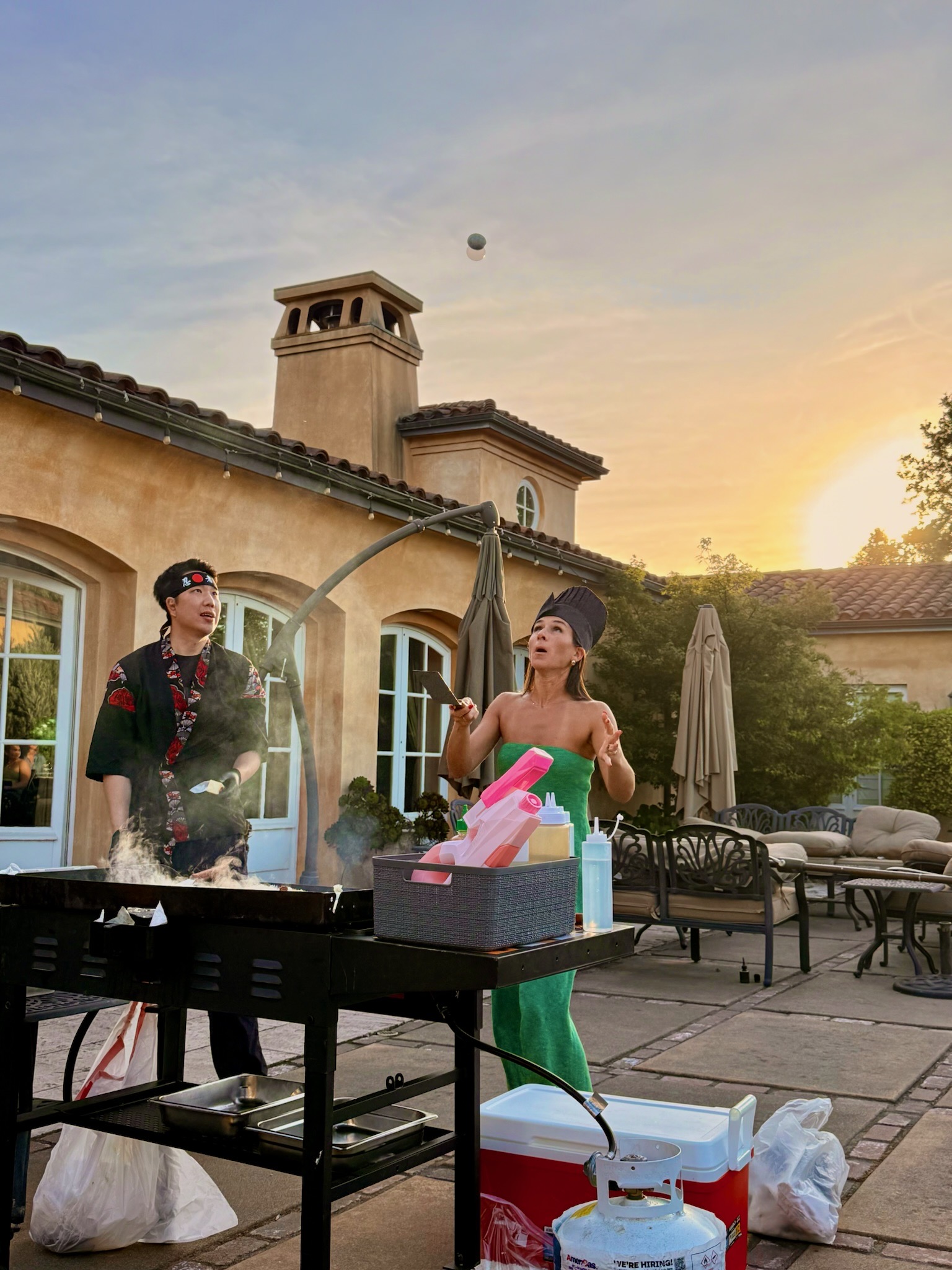 Family vacation group gathered around hibachi grill at an Orlando rental home